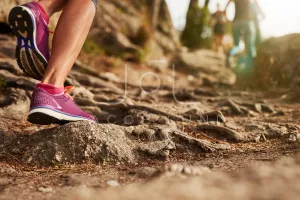 Close up of an athlete's feet running on a dirt track